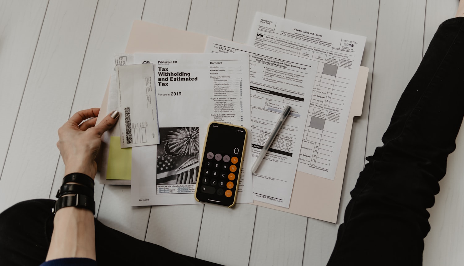 Tax return paperwork and calculator on a desk